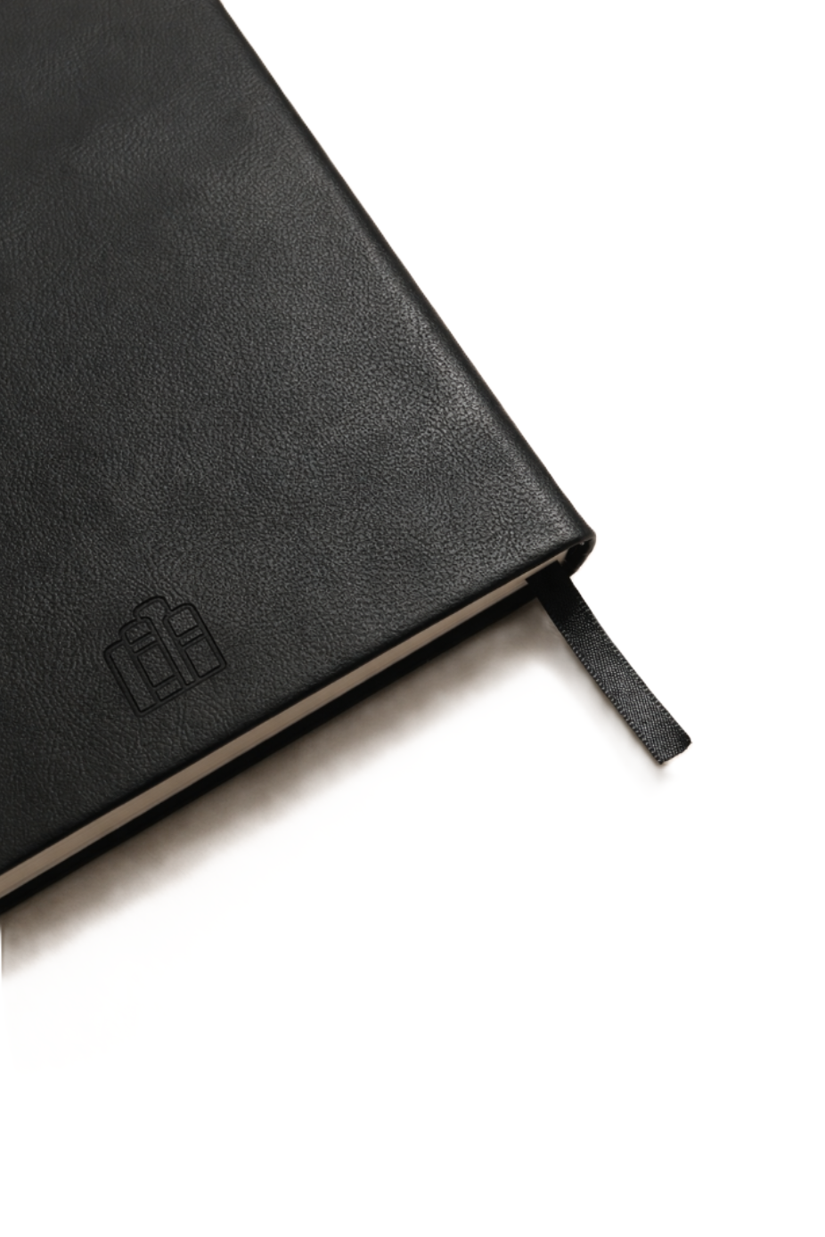 Close-up of black leather journal cover showing textured finish and minimal debossed logo detail.